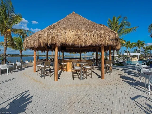 a view of a lake with couches chairs