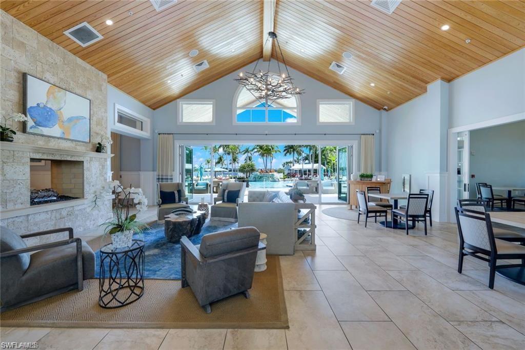 14614 Stillwater Way Naples, FL 34114 - Photo 44 of 47 a living room with furniture a fireplace and a chandelier