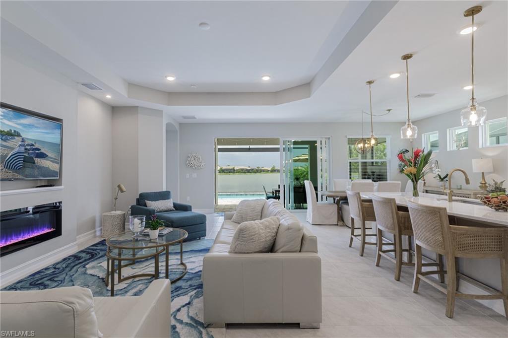 14614 Stillwater Way Naples, FL 34114 - Photo 5 of 47 a living room with furniture and a large window