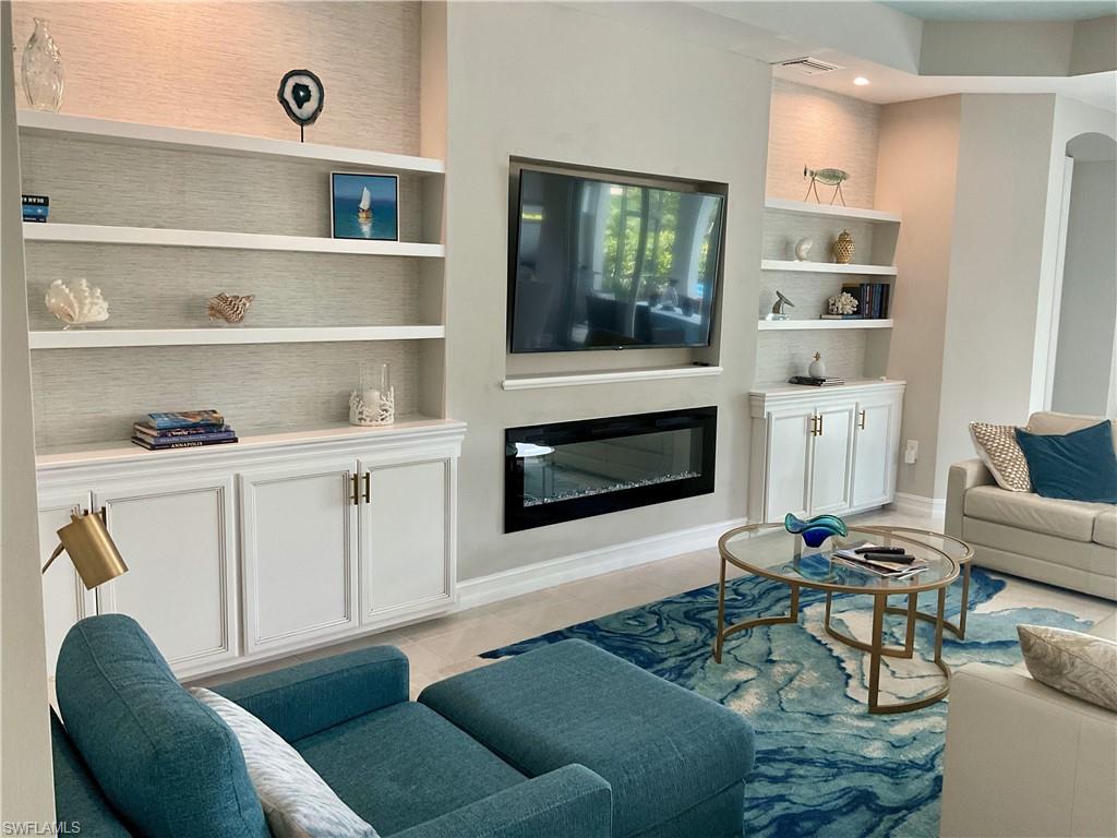 14614 Stillwater Way Naples, FL 34114 - Photo 6 of 47 a living room with furniture and a fireplace