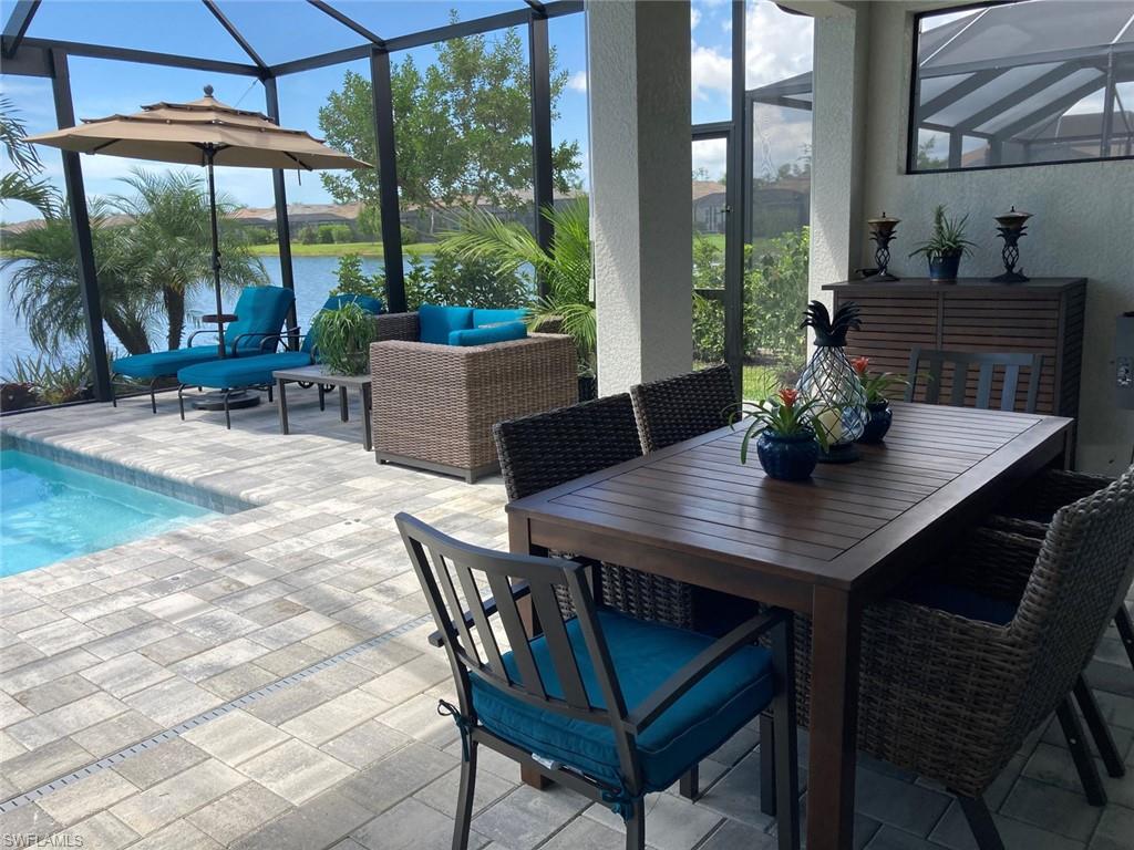 14614 Stillwater Way Naples, FL 34114 - Photo 8 of 47 a view of an outdoor dining space with furniture