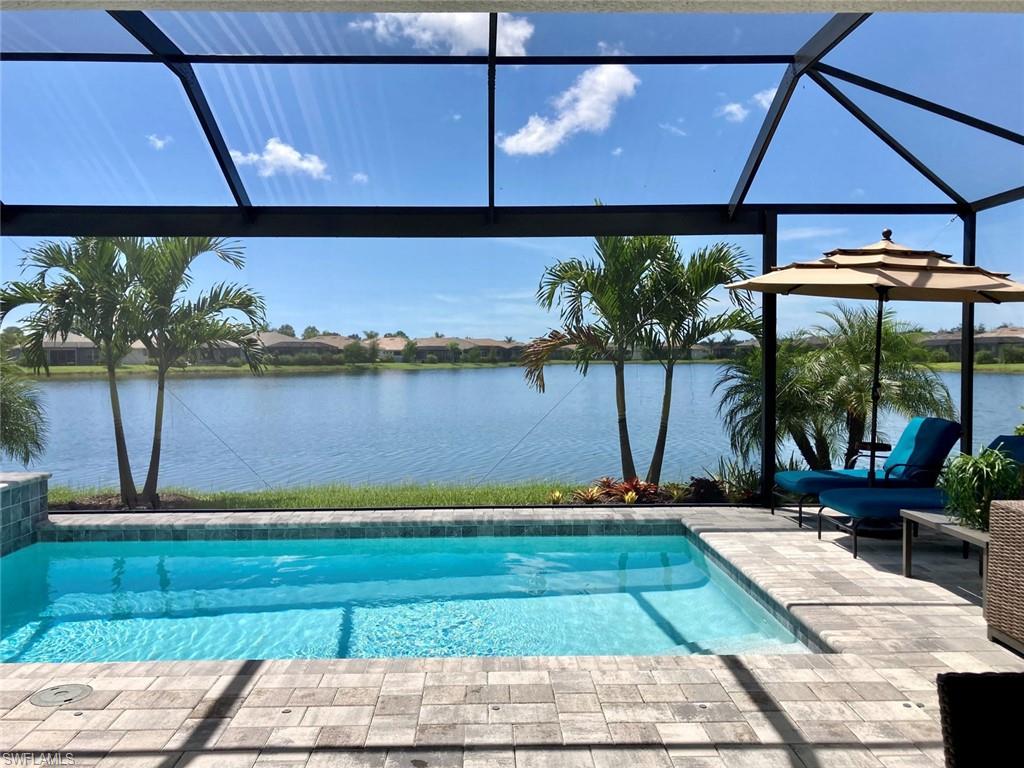 14614 Stillwater Way Naples, FL 34114 - Photo 9 of 47 a view of a swimming pool with an outdoor space and seating area