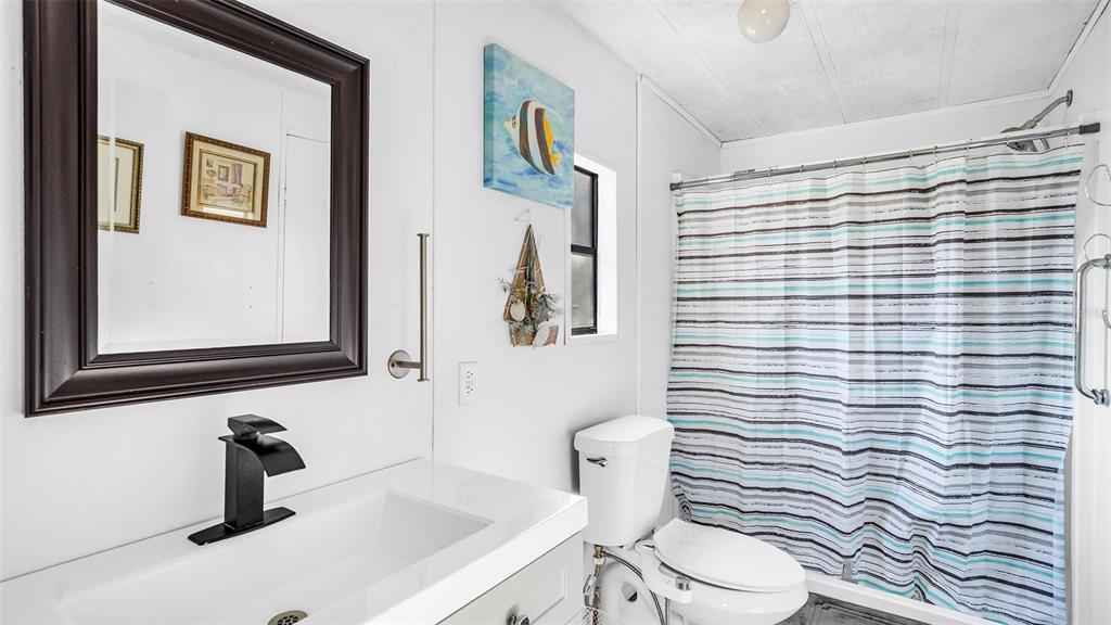 13035 Jack Terrace Hudson, FL 34669 - Photo 11 of 18 a bathroom with a sink a toilet and mirror