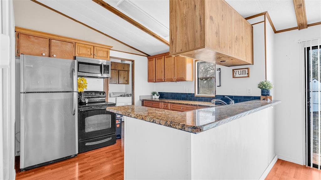 13035 Jack Terrace Hudson, FL 34669 - Photo 6 of 18 a kitchen with granite countertop a refrigerator and a sink