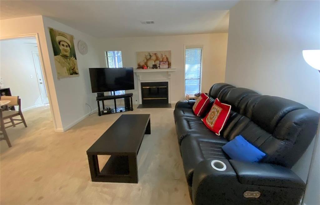 3934 Woodridge Way Tucker, GA 30084 - Photo 16 of 75 a living room with furniture fireplace and a flat screen tv