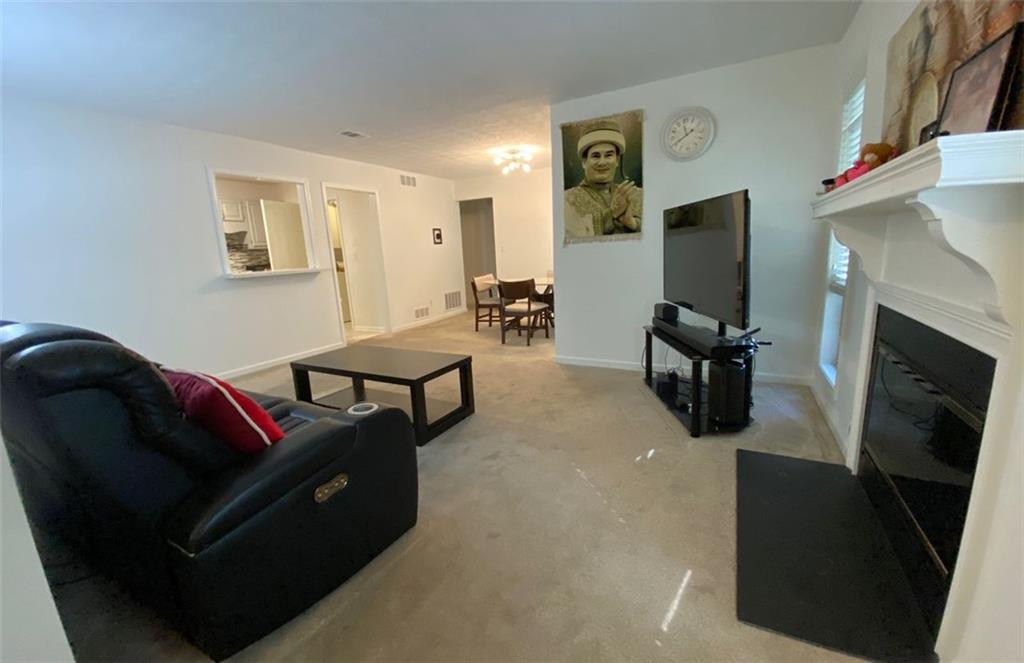 3934 Woodridge Way Tucker, GA 30084 - Photo 18 of 75 a living room with furniture and a flat screen tv