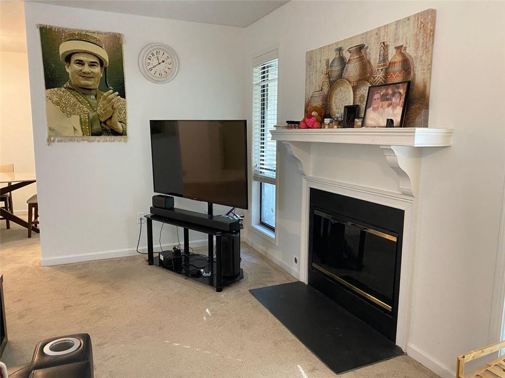 3934 Woodridge Way Tucker, GA 30084 - Photo 19 of 75 a living room with furniture and a fireplace
