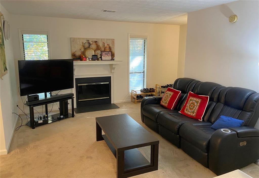 3934 Woodridge Way Tucker, GA 30084 - Photo 21 of 75 a living room with furniture and a fireplace