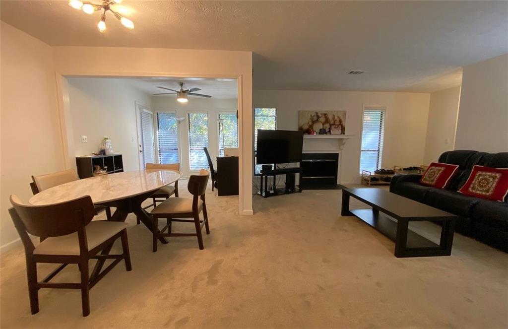 3934 Woodridge Way Tucker, GA 30084 - Photo 23 of 75 a living room with furniture and a flat screen tv