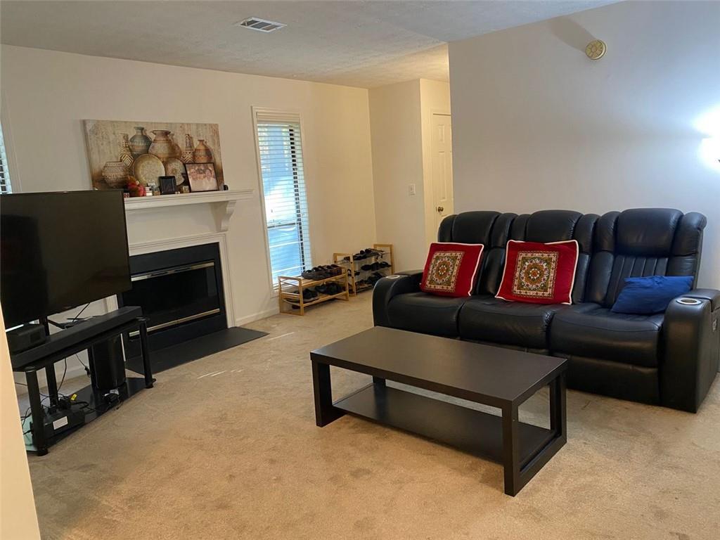 3934 Woodridge Way Tucker, GA 30084 - Photo 25 of 75 a living room with furniture and a fireplace