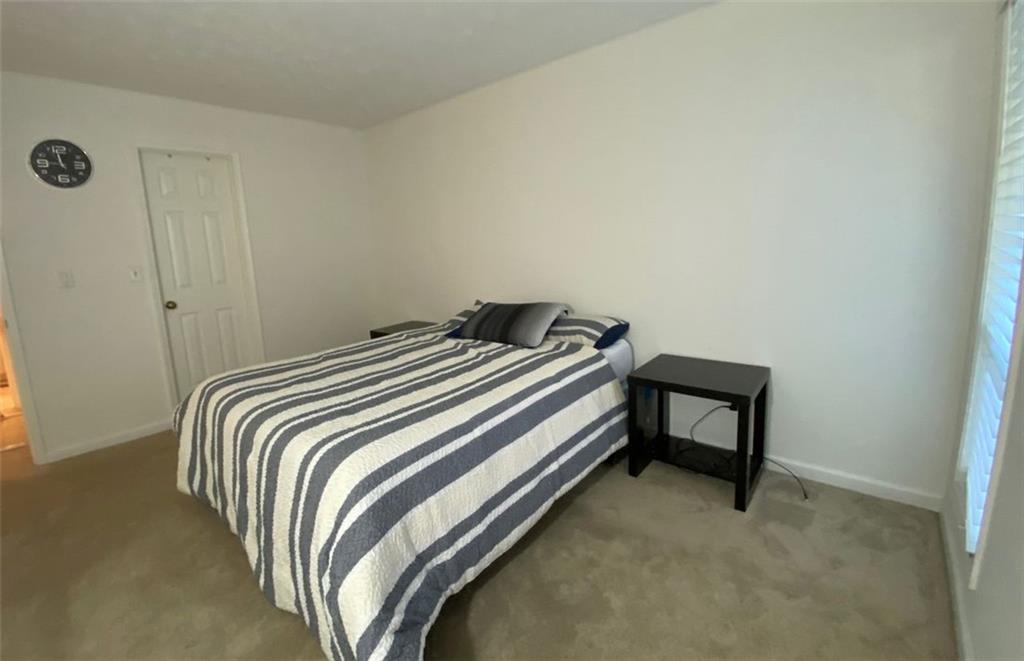 3934 Woodridge Way Tucker, GA 30084 - Photo 31 of 75 a bedroom with a bed and a table