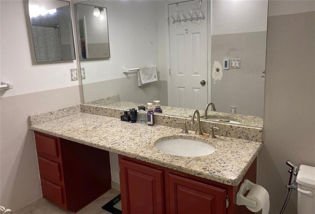3934 Woodridge Way Tucker, GA 30084 - Photo 36 of 75 a bathroom with a granite countertop sink and a mirror