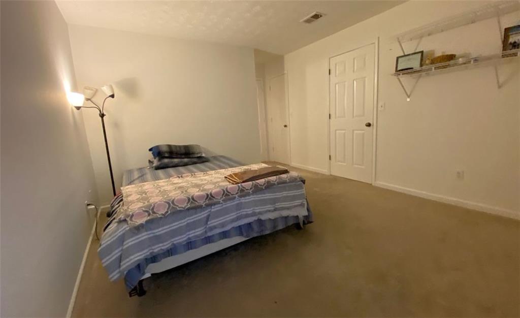 3934 Woodridge Way Tucker, GA 30084 - Photo 44 of 75 a bedroom with a bed and a table