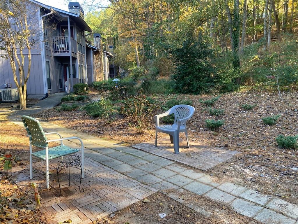 3934 Woodridge Way Tucker, GA 30084 - Photo 49 of 75 a view of a chairs and bench in the backyard of the house