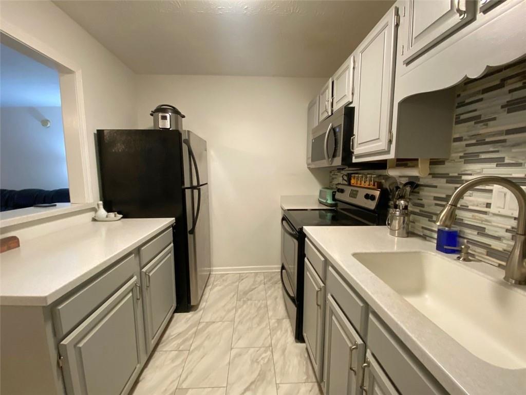 3934 Woodridge Way Tucker, GA 30084 - Photo 9 of 75 a kitchen with a sink stove and refrigerator