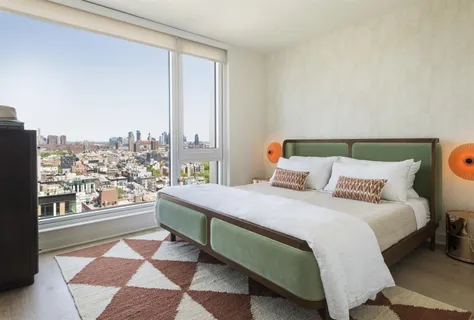 a bedroom with a bed and a night stand