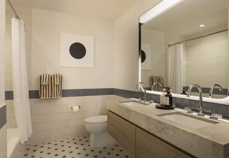 a bathroom with a sink a toilet and a mirror
