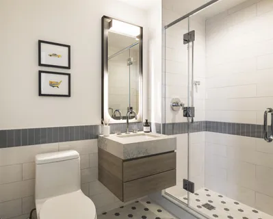 a bathroom with a sink a toilet and mirror