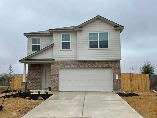 a front view of a house with garage