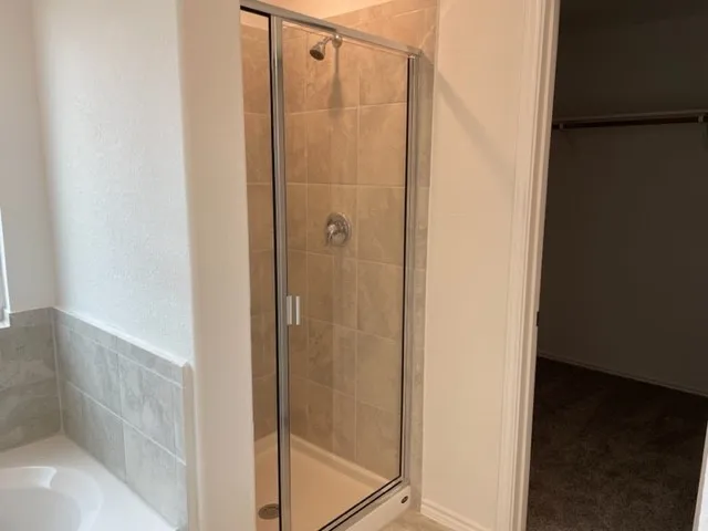a bathroom with a glass shower door
