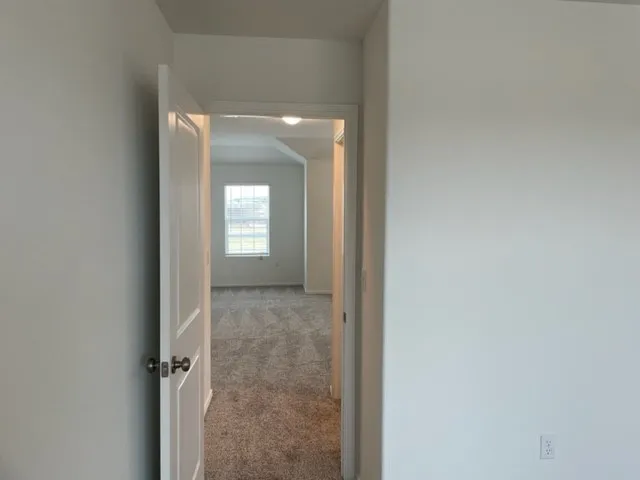a view of a bathroom from a hallway