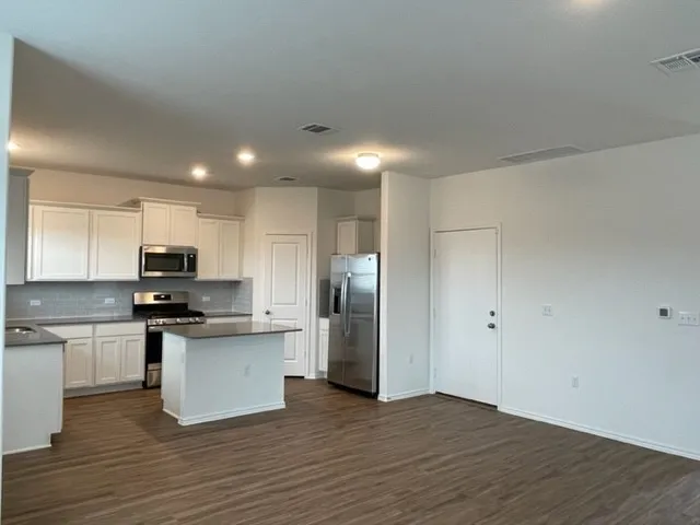 a kitchen with a sink and a refrigerator