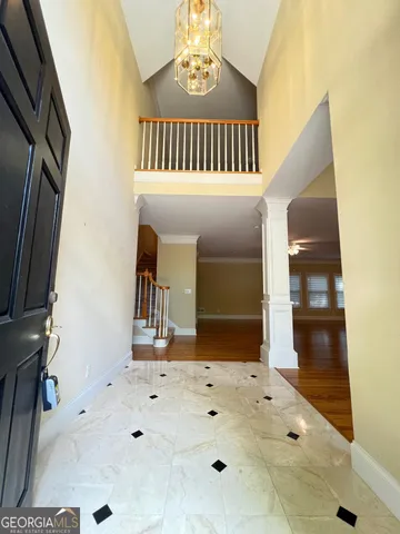 a view of a big room with wooden floor and a kitchen