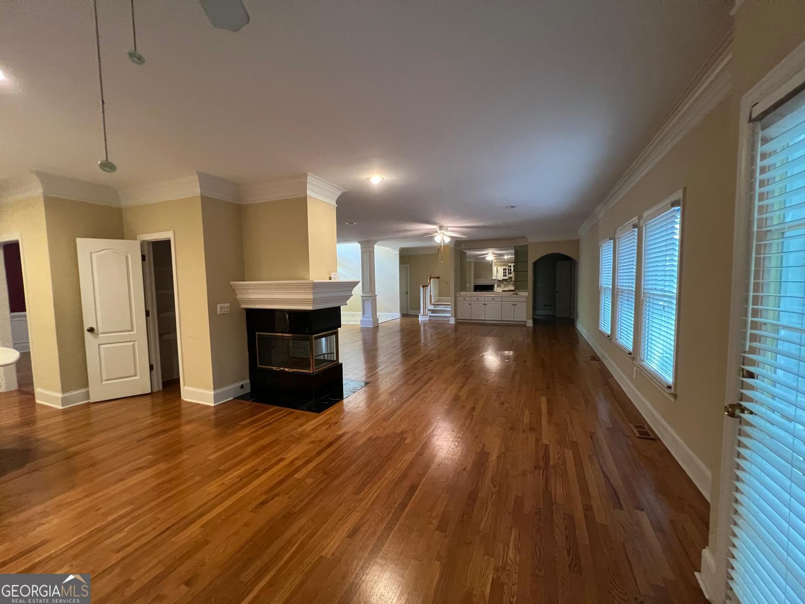 2301 Castlemaine Drive Northwest Duluth, GA 30097 - Photo 17 of 89 a view of a big room with wooden floor and a kitchen