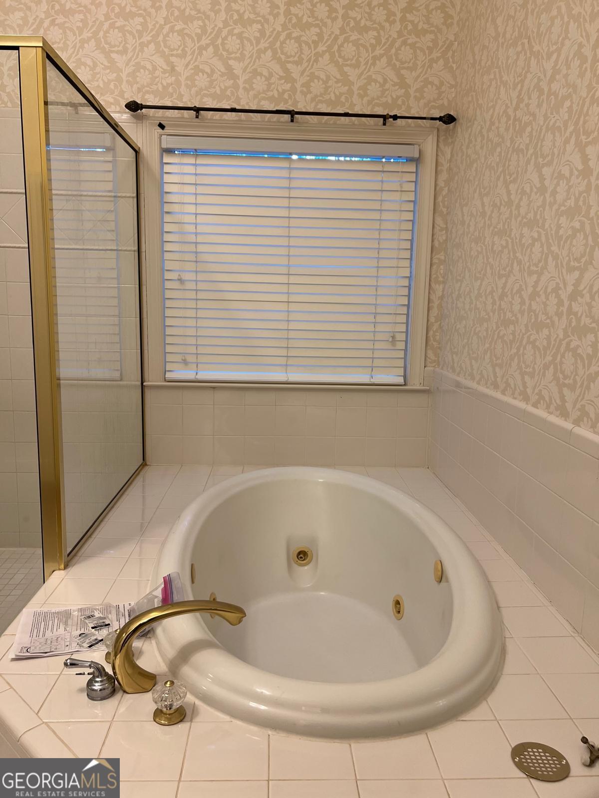 2301 Castlemaine Drive Northwest Duluth, GA 30097 - Photo 38 of 89 a bathroom with a tub and a shower