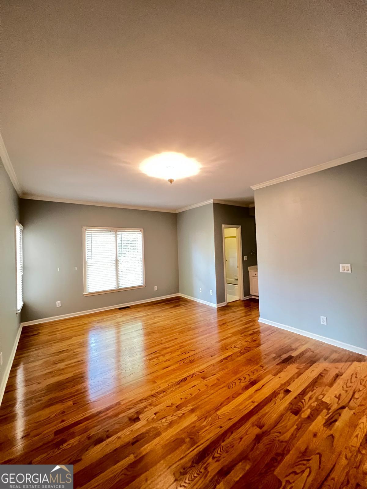 2301 Castlemaine Drive Northwest Duluth, GA 30097 - Photo 42 of 89 a view of an empty room with window and wooden floor