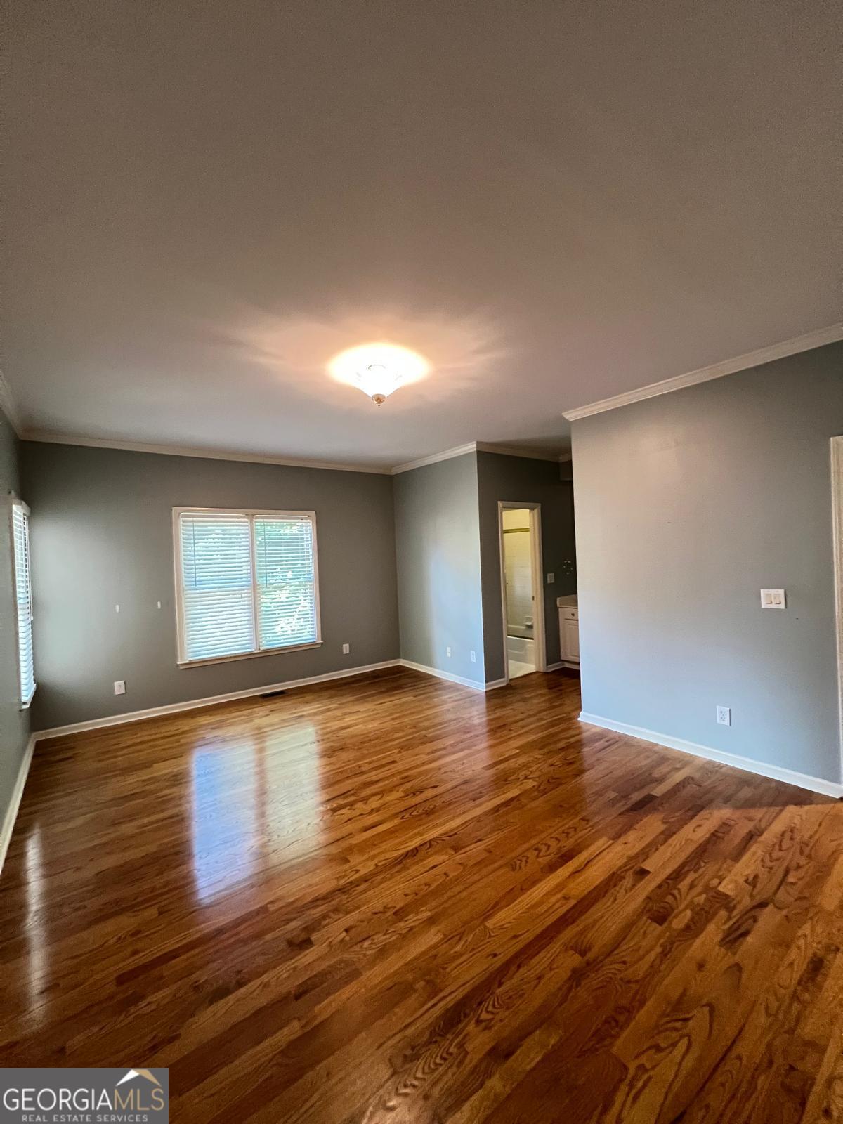 2301 Castlemaine Drive Northwest Duluth, GA 30097 - Photo 43 of 89 a view of an empty room with window and wooden floor