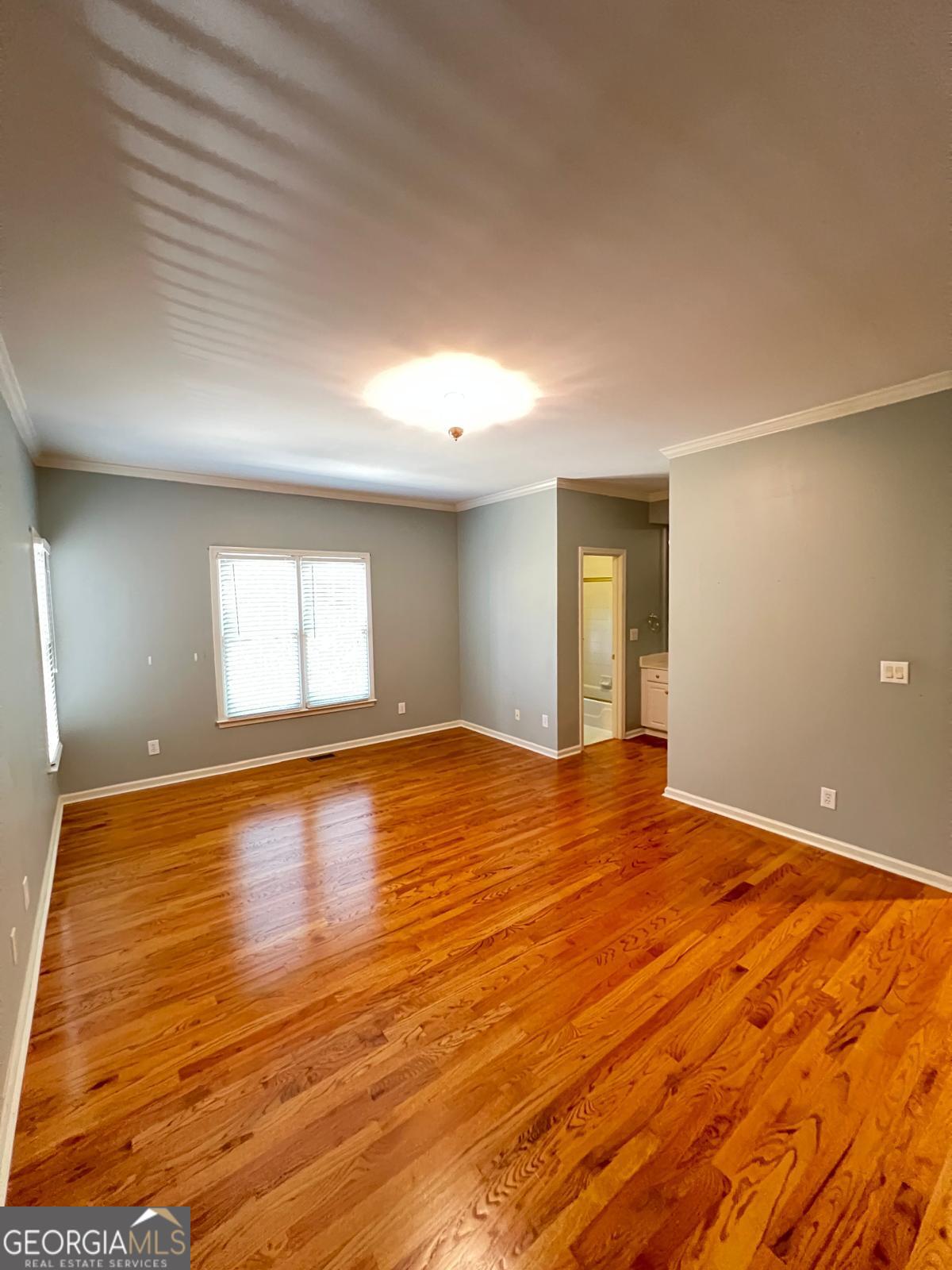 2301 Castlemaine Drive Northwest Duluth, GA 30097 - Photo 44 of 89 a view of empty room with wooden floor and fan