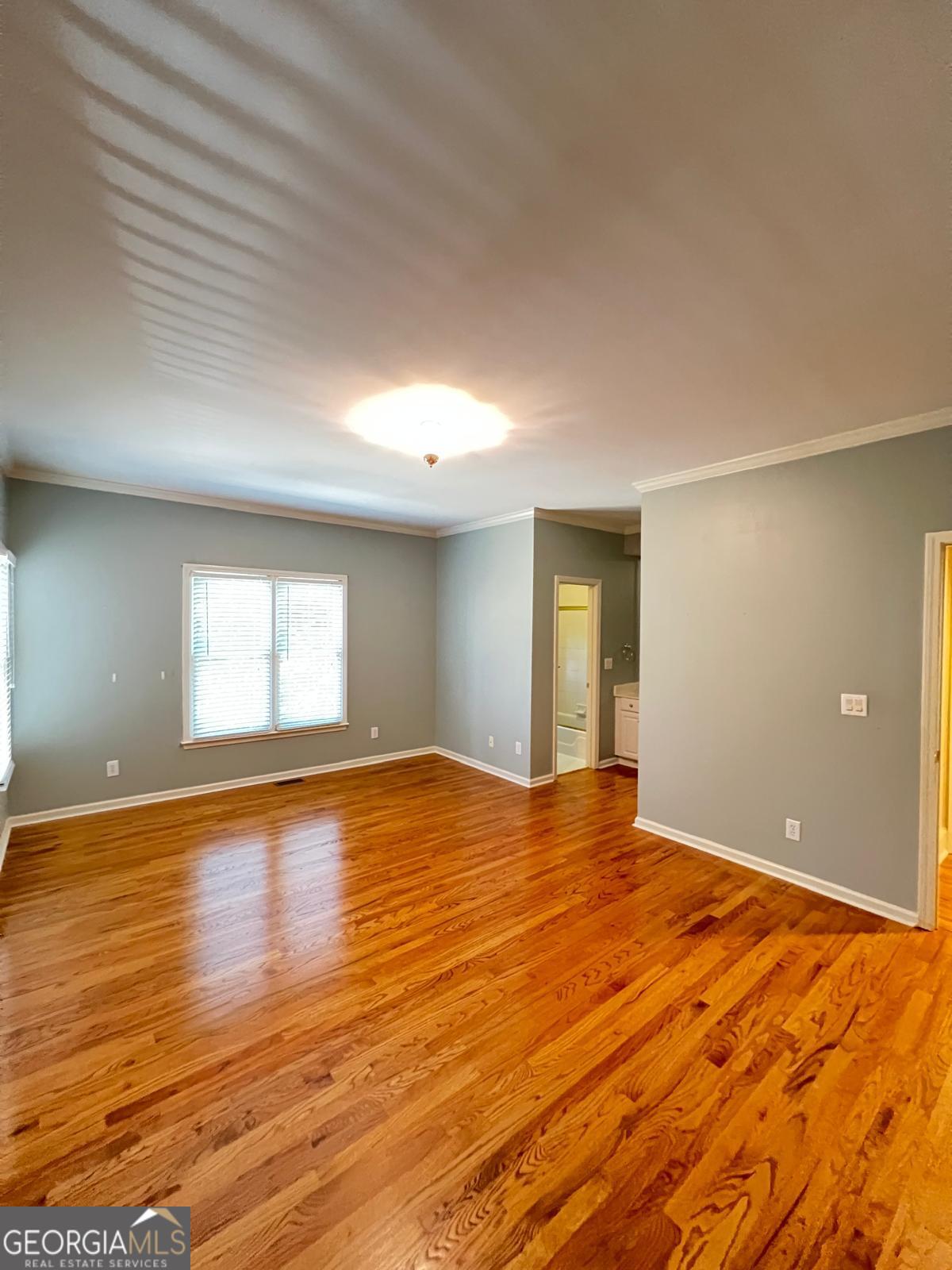 2301 Castlemaine Drive Northwest Duluth, GA 30097 - Photo 45 of 89 a view of empty room with wooden floor and fan