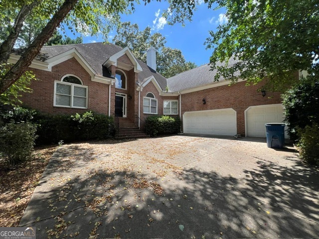 2301 Castlemaine Drive Northwest Duluth, GA 30097 - Photo 5 of 89 a front view of a house with a yard and garage