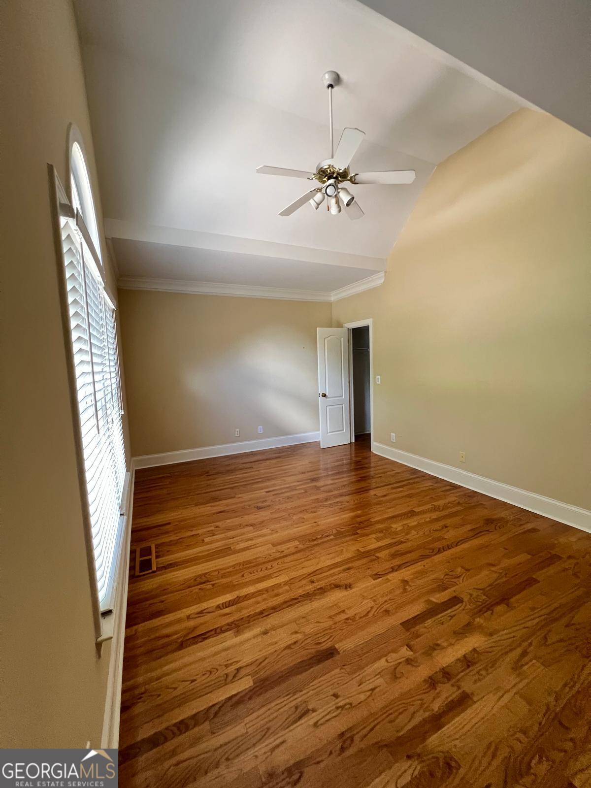 2301 Castlemaine Drive Northwest Duluth, GA 30097 - Photo 54 of 89 a view of an empty room with wooden floor and fan