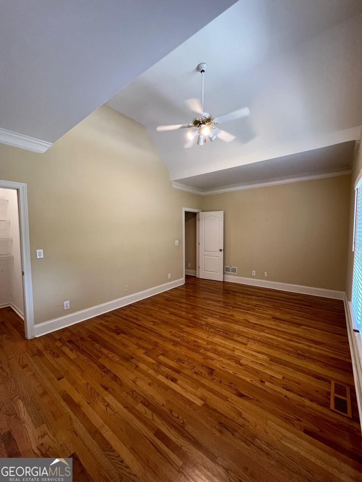 2301 Castlemaine Drive Northwest Duluth, GA 30097 - Photo 60 of 89 a view of an empty room with wooden floor and a ceiling fan
