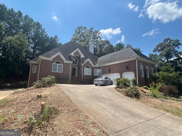 2301 Castlemaine Drive Northwest Duluth, GA 30097 - Photo 83 of 89 a front view of a house with a yard and potted plants