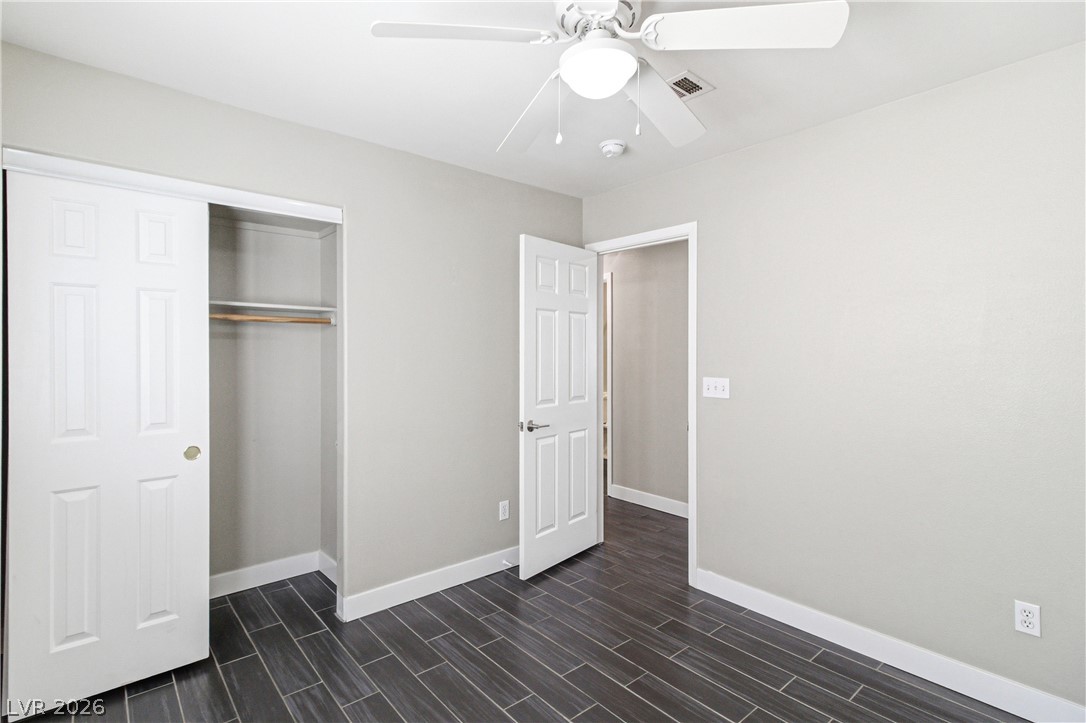 9523 Observer Street Las Vegas, NV 89123 - Photo 22 of 42 Newly updated bedroom with rich wood-look tile flooring and a refreshing ceiling fan.