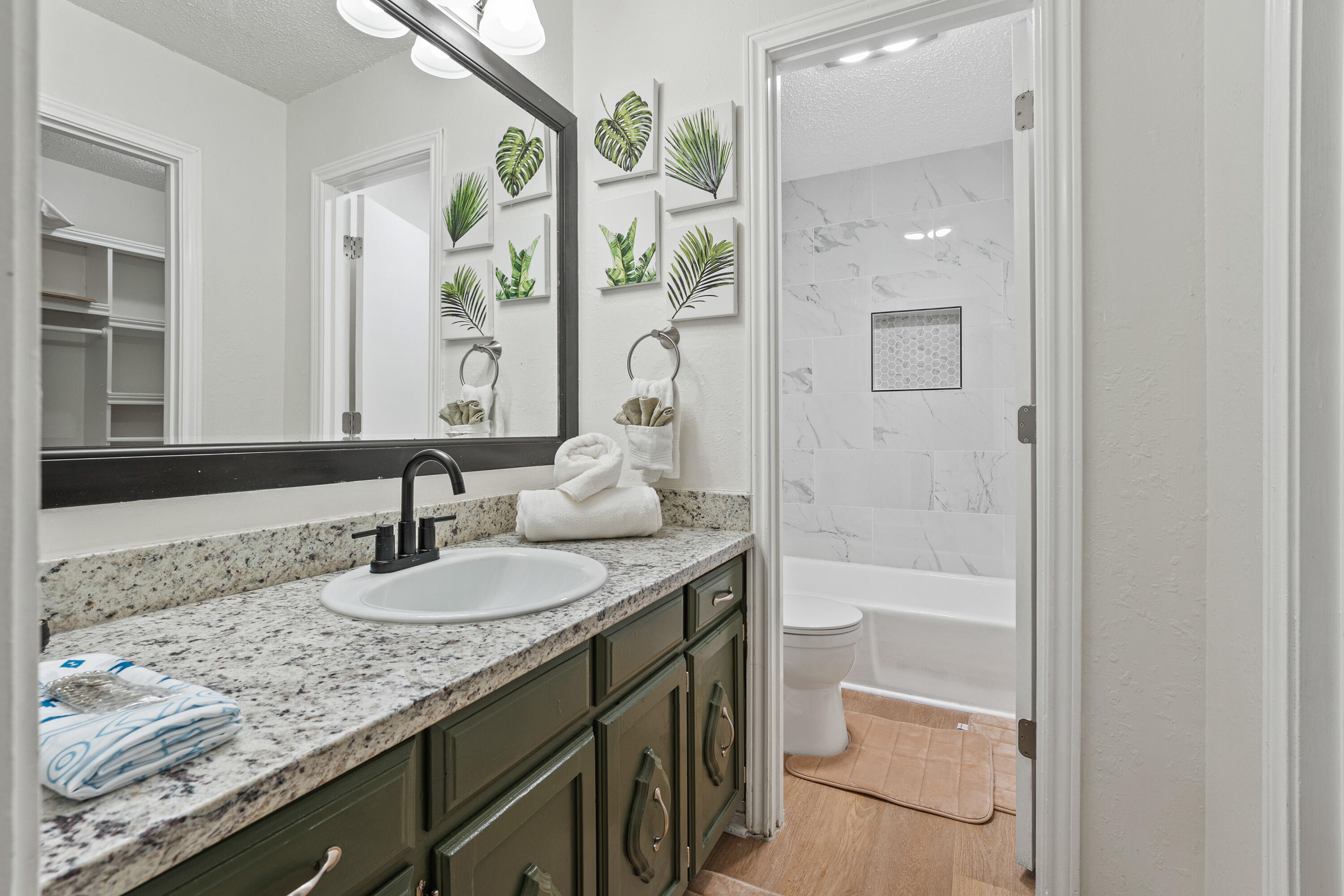 4510 77th Street Lubbock, TX 79424 - Photo 12 of 26 a bathroom with a granite countertop sink and a mirror