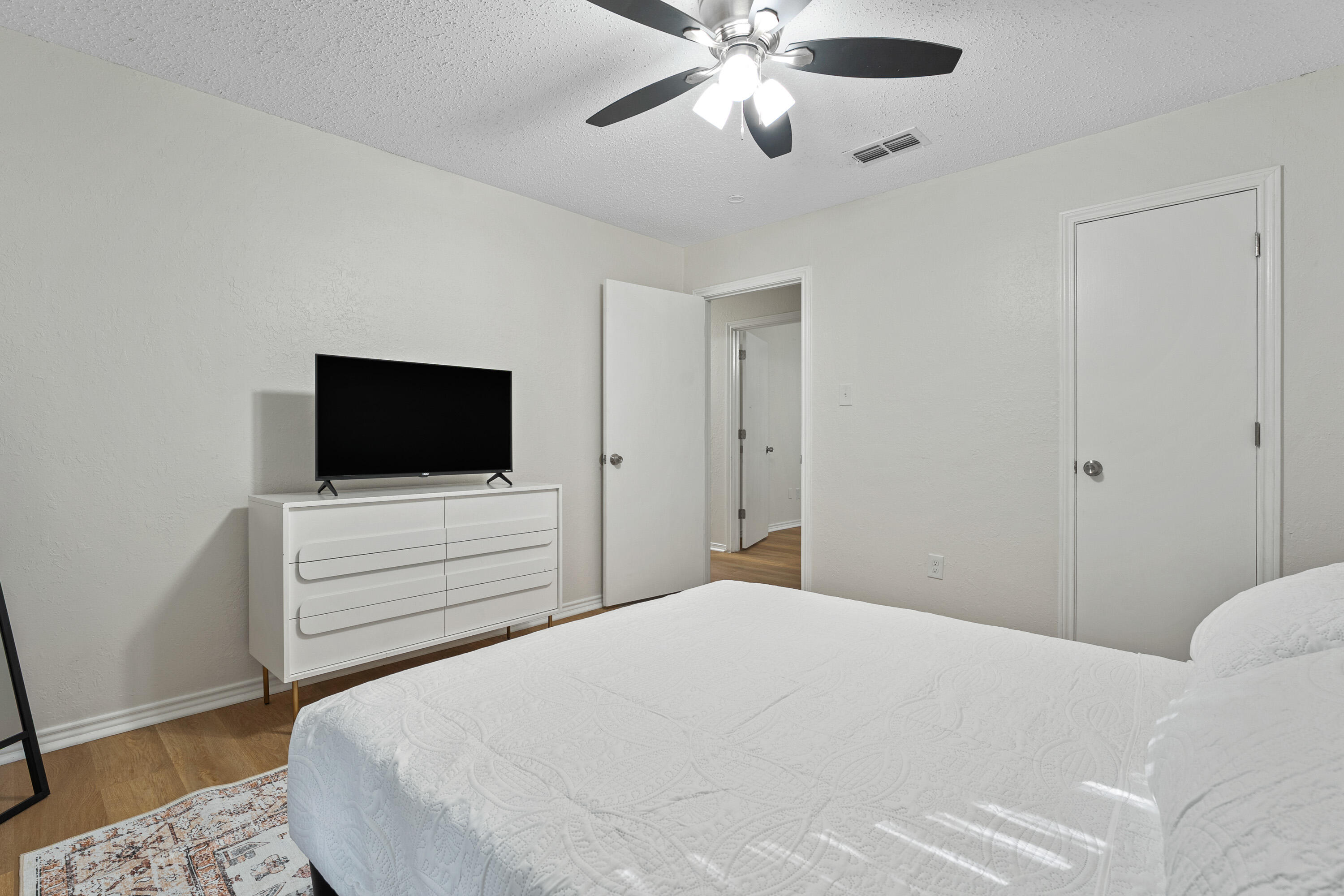 4510 77th Street Lubbock, TX 79424 - Photo 17 of 26 a bedroom with a bed and a flat screen tv