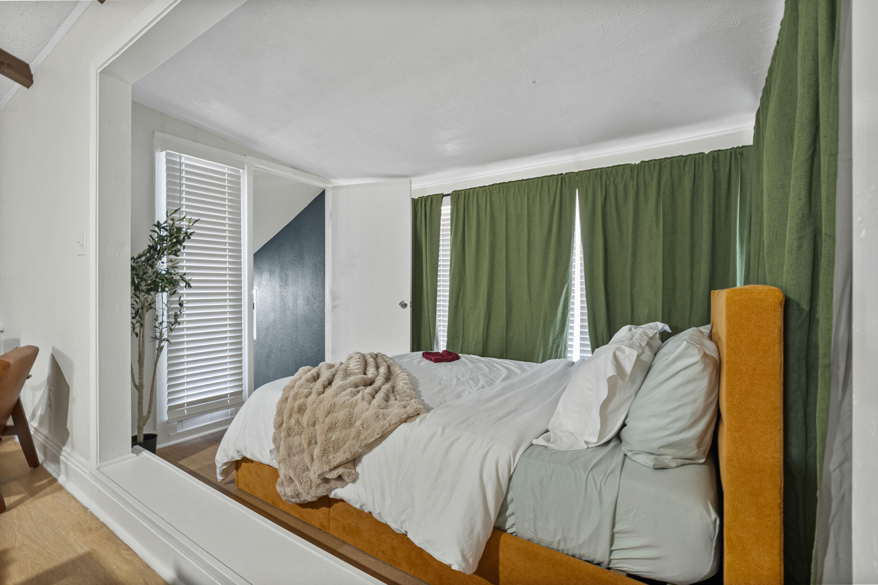 4510 77th Street Lubbock, TX 79424 - Photo 20 of 26 a bed sitting in a bedroom next to a window and walk in closet