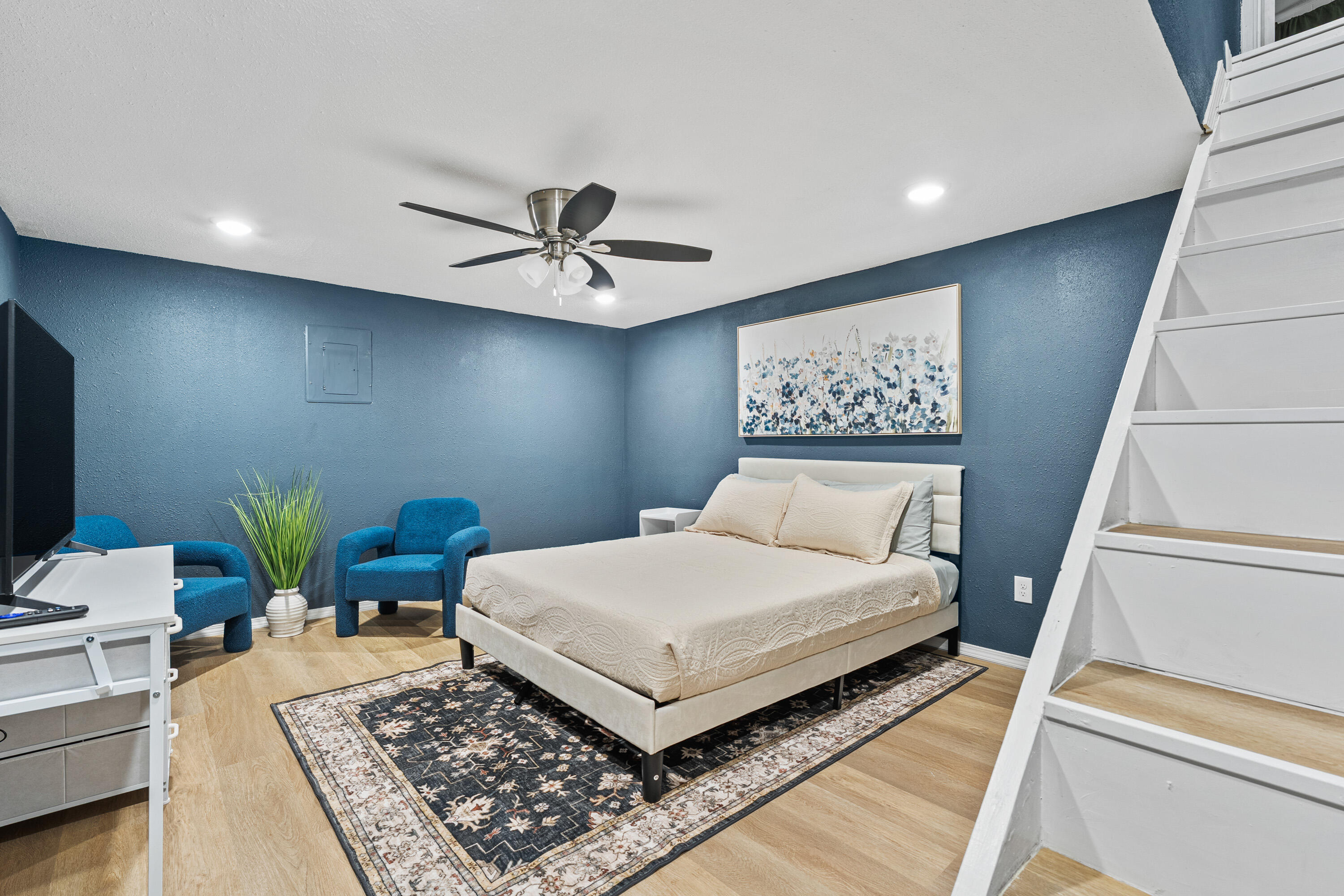 4510 77th Street Lubbock, TX 79424 - Photo 21 of 26 a bedroom with a bed a rug and a couch