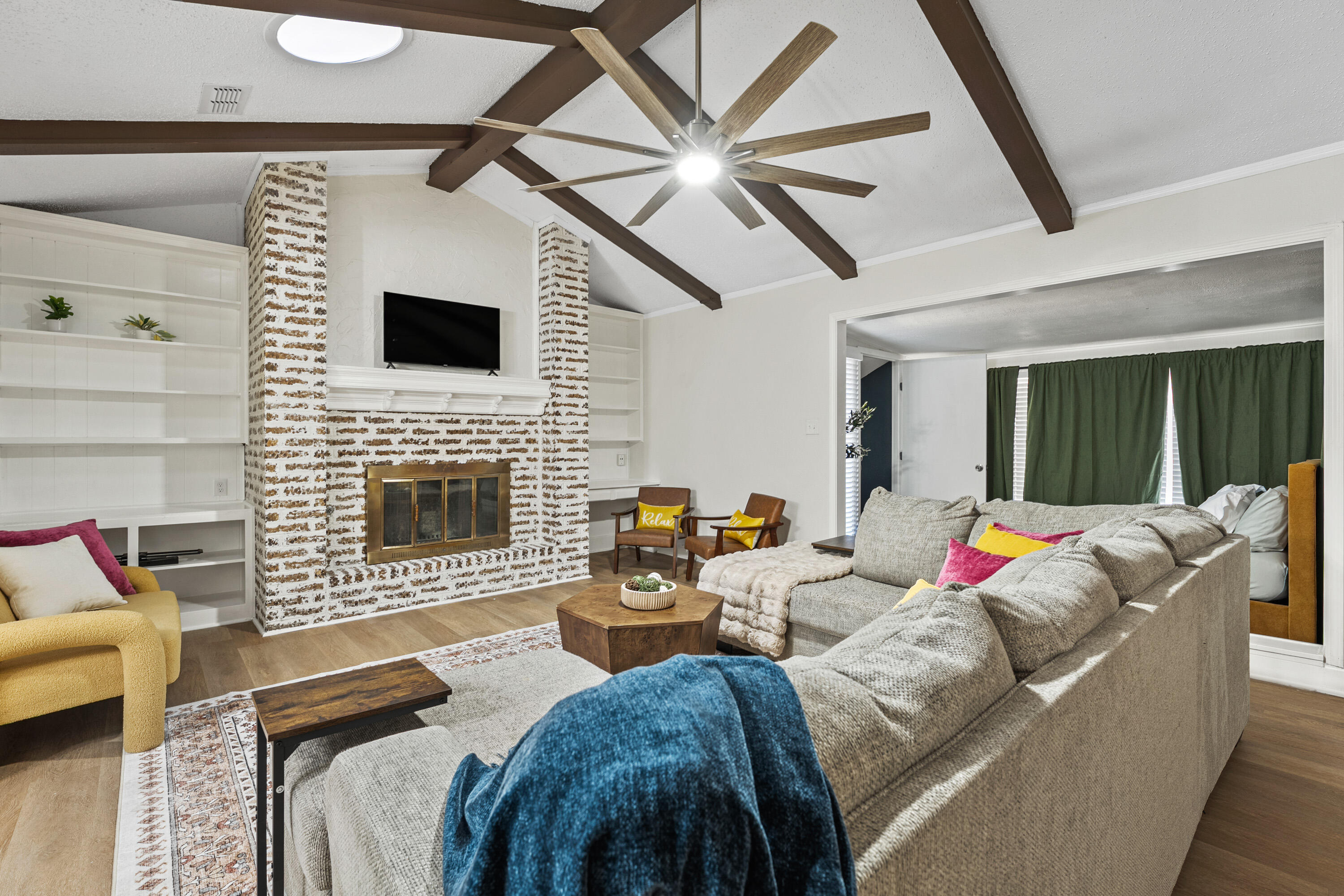 4510 77th Street Lubbock, TX 79424 - Photo 4 of 26 a living room with furniture a fireplace and a flat screen tv