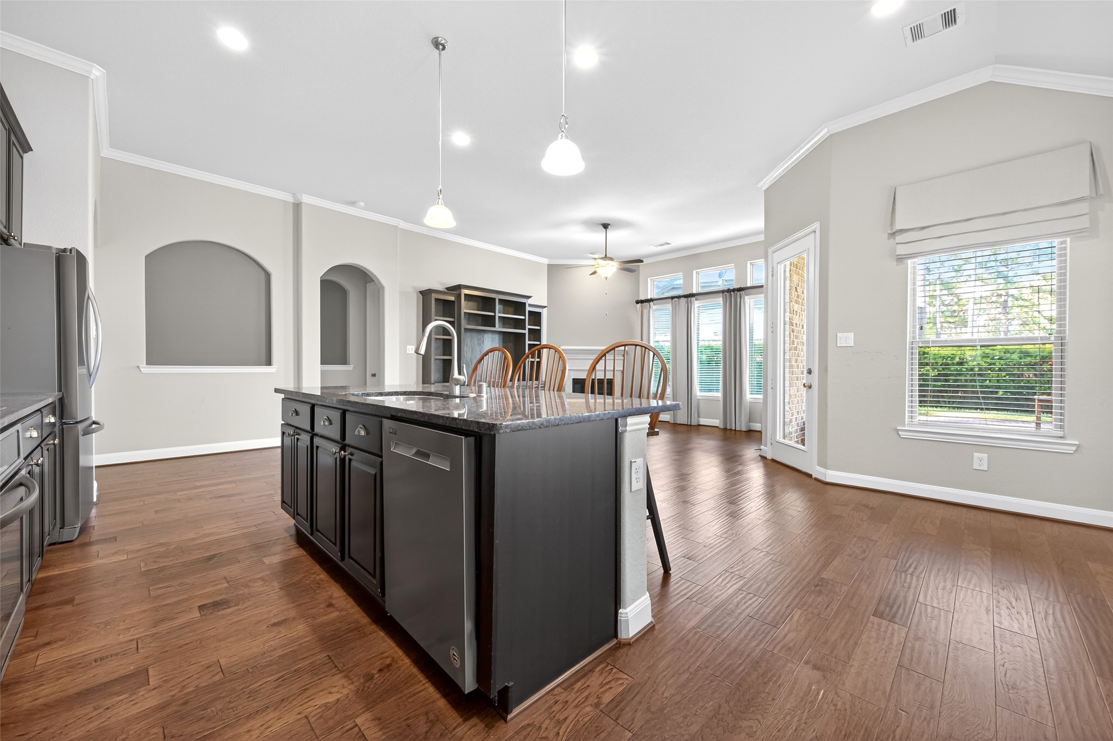 14 South Sawbridge Circle Spring, TX 77389 - Photo 17 of 45 a kitchen with stainless steel appliances granite countertop a refrigerator a sink dishwasher a oven and a dining table with wooden floor