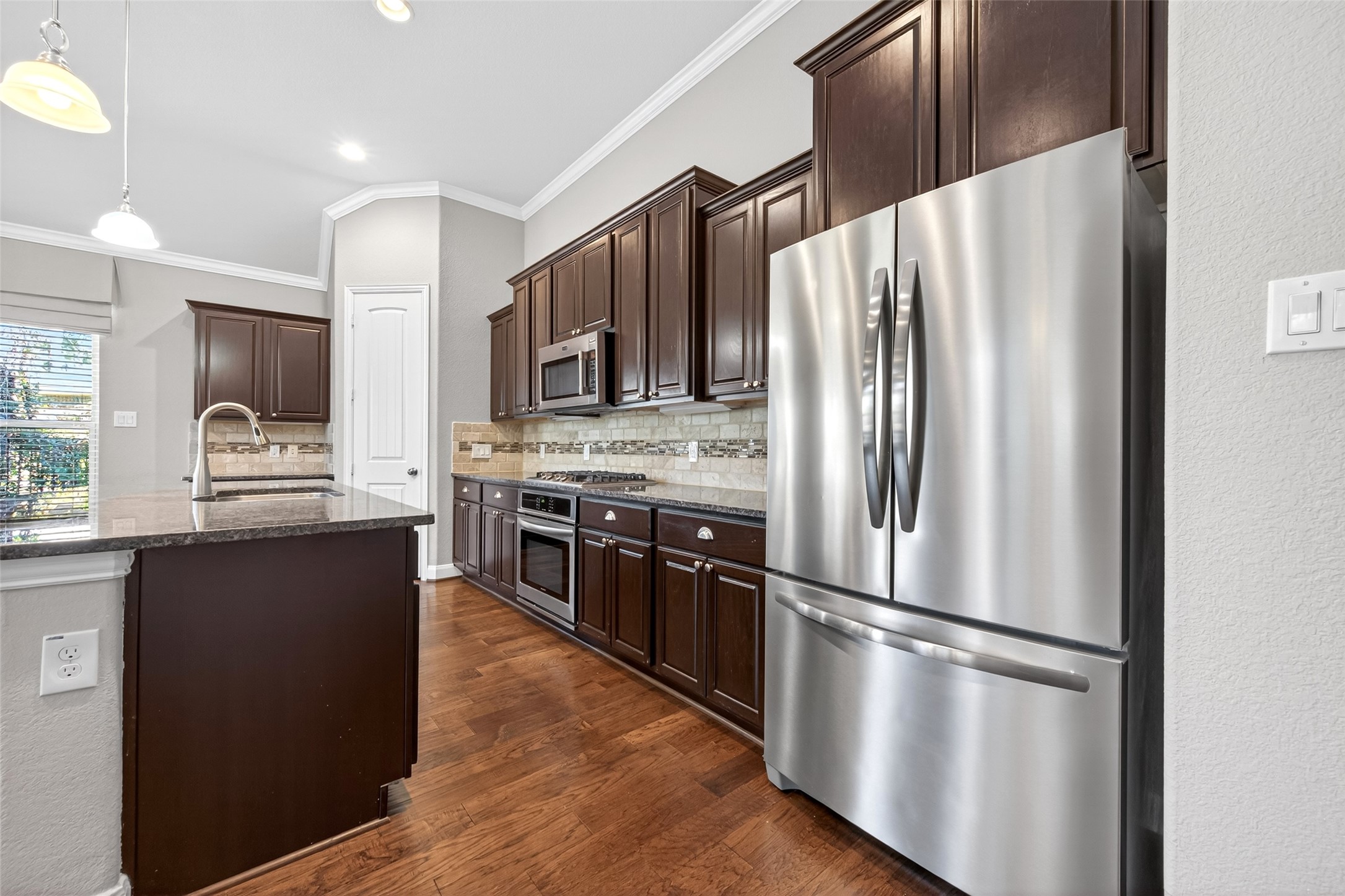 14 South Sawbridge Circle Spring, TX 77389 - Photo 19 of 45 a kitchen with stainless steel appliances a refrigerator and a stove top oven
