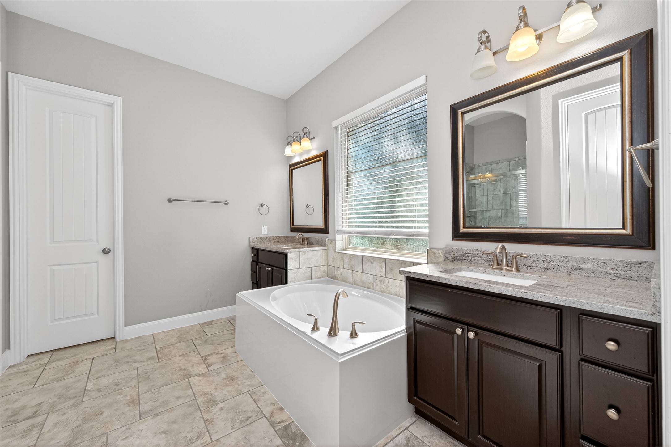 14 South Sawbridge Circle Spring, TX 77389 - Photo 33 of 45 a bathroom with a sink vanity tub and a mirror