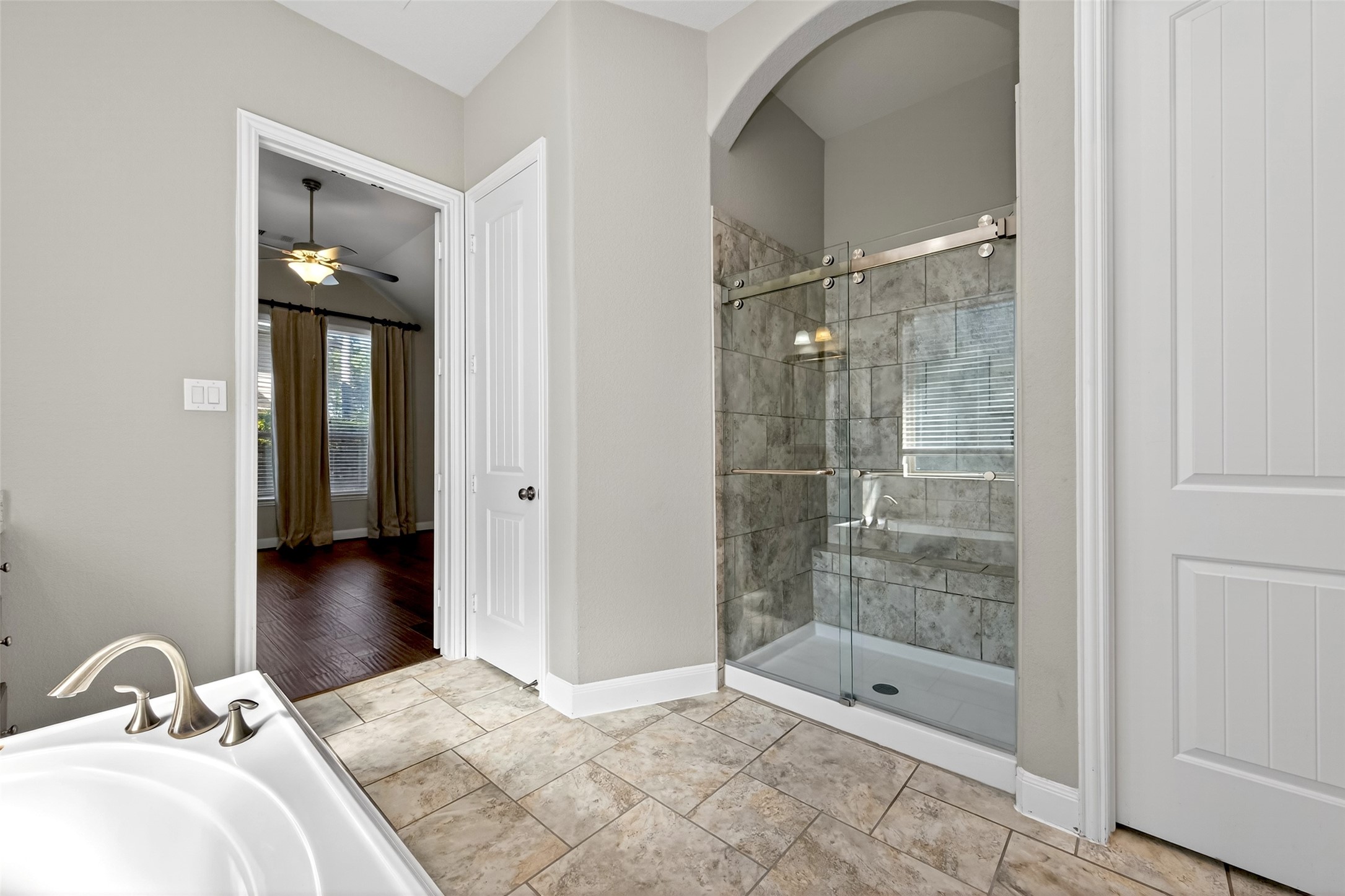 14 South Sawbridge Circle Spring, TX 77389 - Photo 34 of 45 a bathroom with a bathtub and a shower