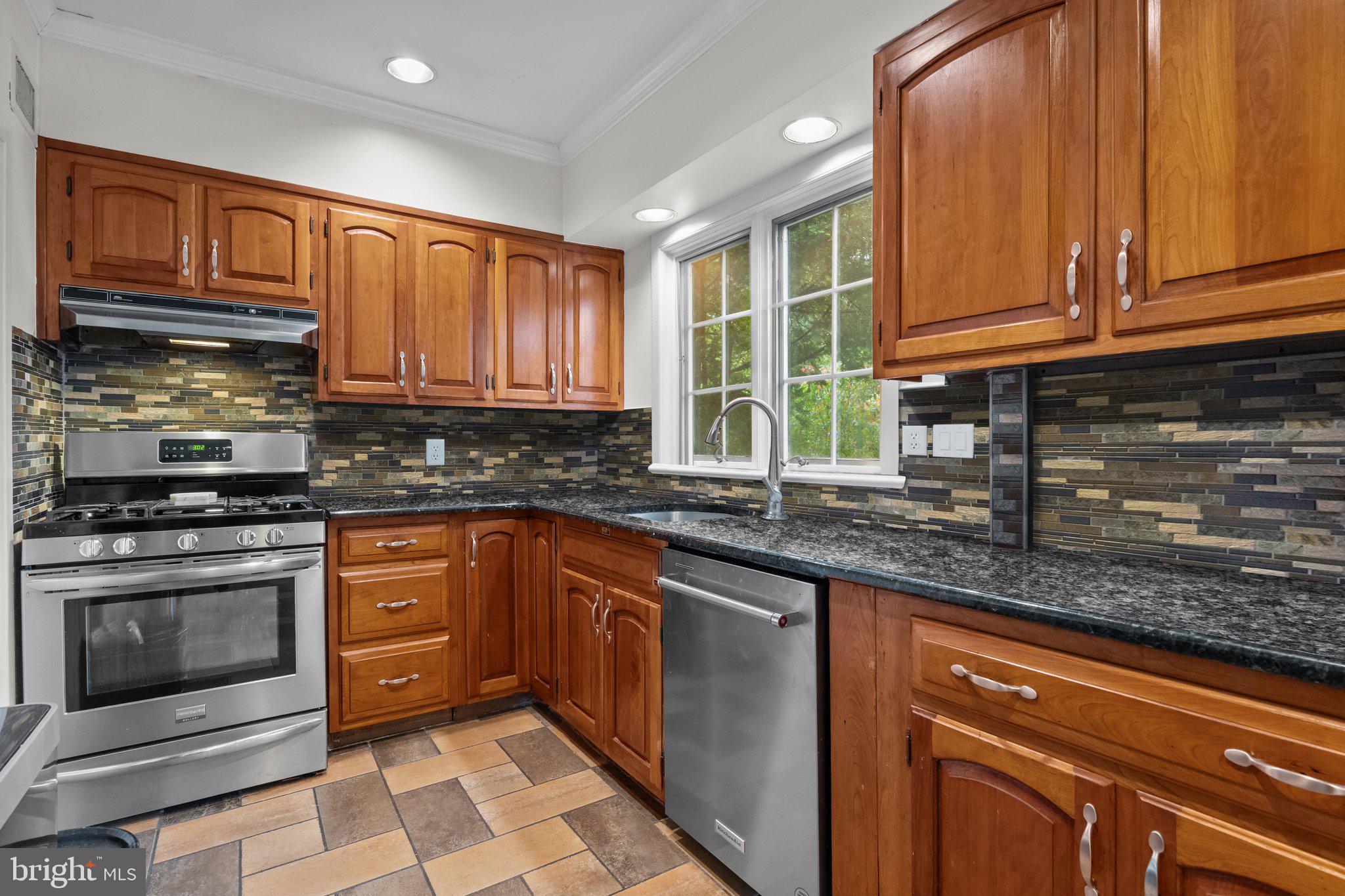 600 Runnymede Avenue Jenkintown, PA 19046 - Photo 20 of 51 a kitchen with stainless steel appliances granite countertop a stove sink and cabinets