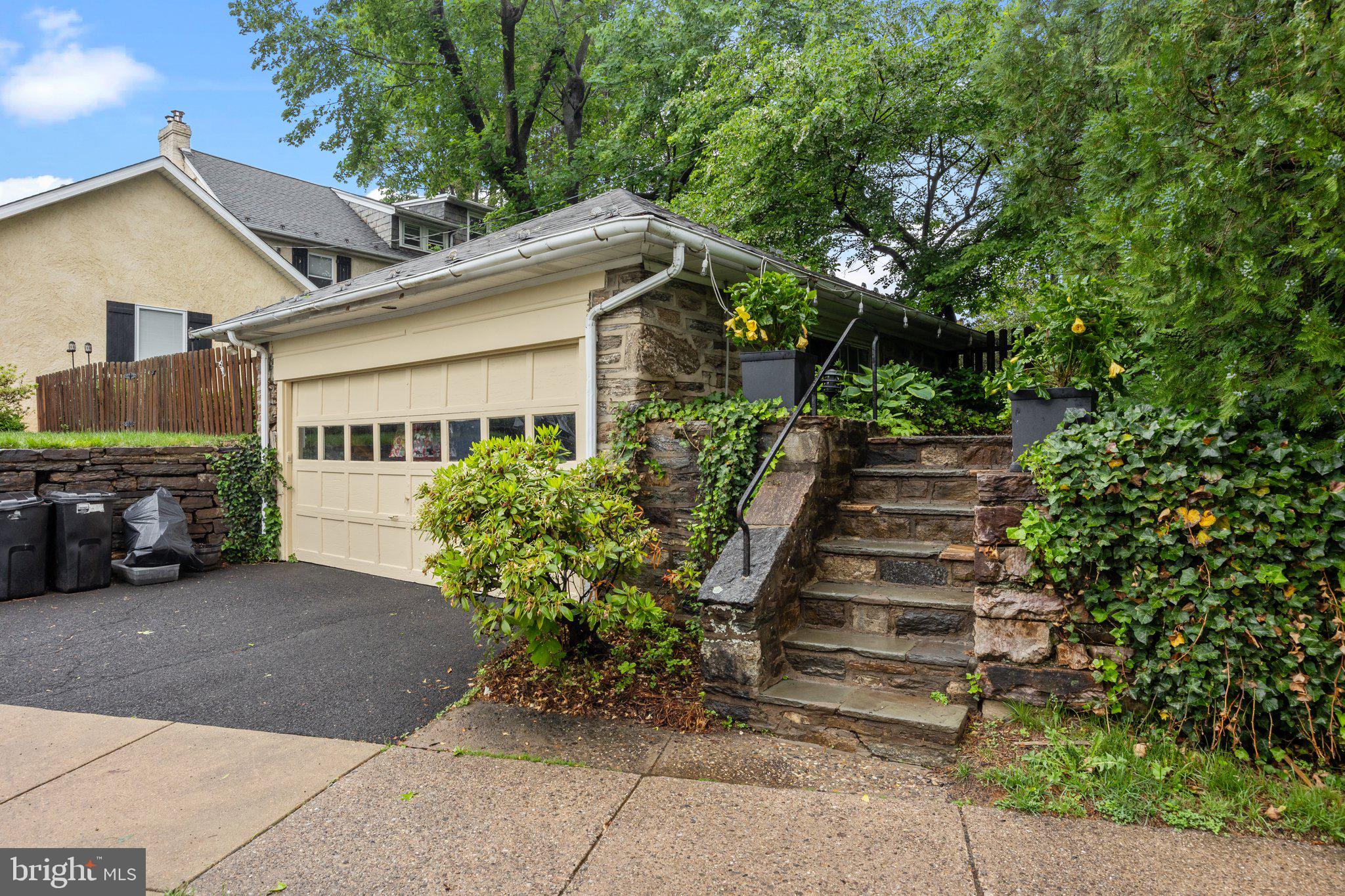 600 Runnymede Avenue Jenkintown, PA 19046 - Photo 41 of 51 a view of a house with a yard plants and a car parked in front of it