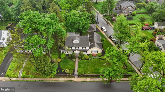 an aerial view of a house with a yard and outdoor seating